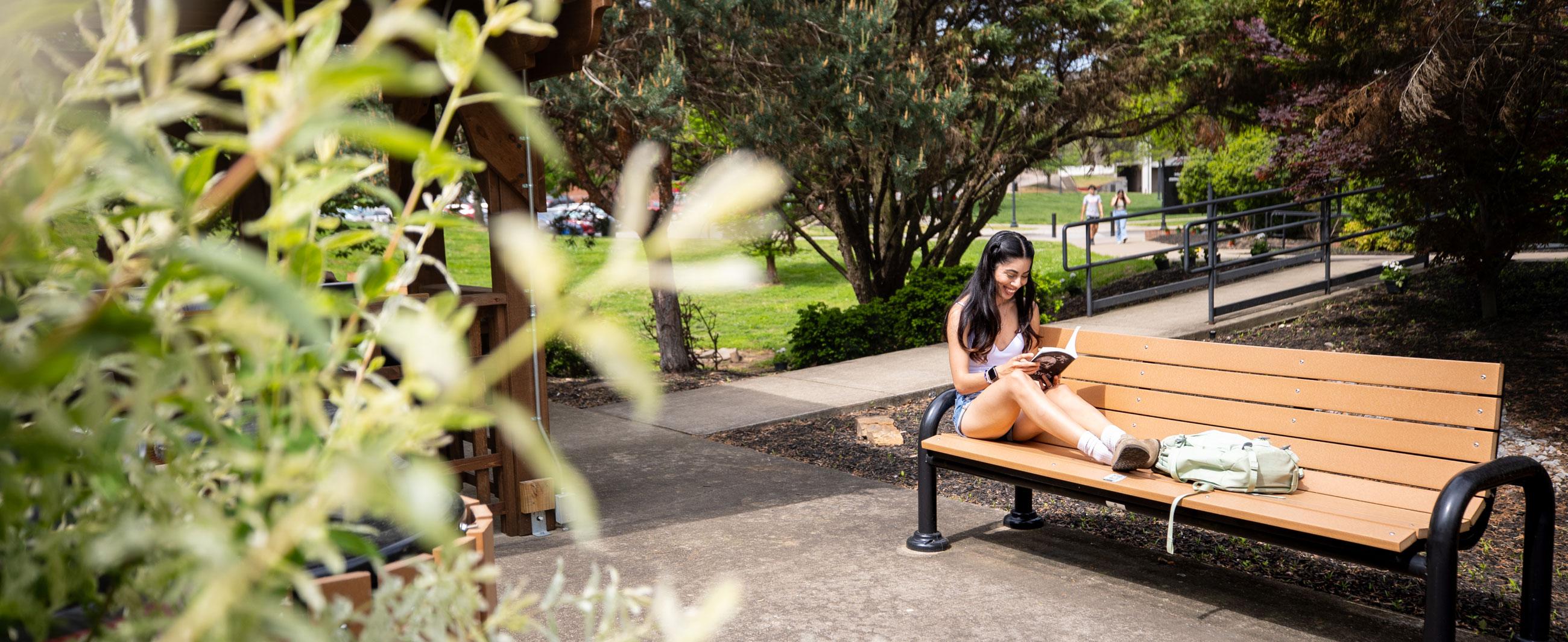 Student reading on campus